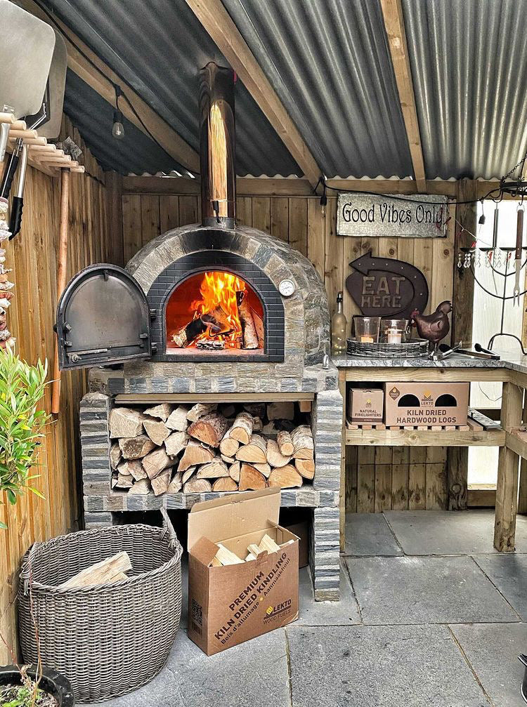 Lekto wood fuels surrounding an outdoor wood burning oven