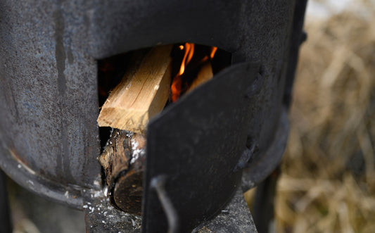 Woman Sat By A Wood Burning Stove